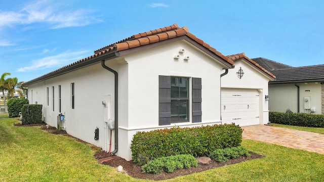 view of home's exterior featuring a yard and a garage