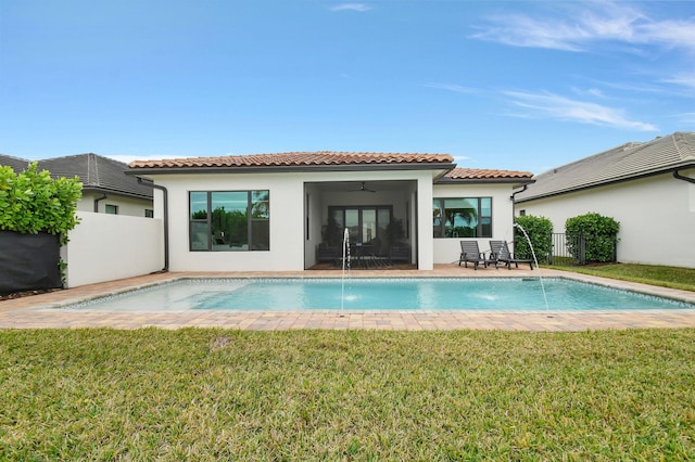 rear view of house with a lawn, pool water feature, ceiling fan, and a patio