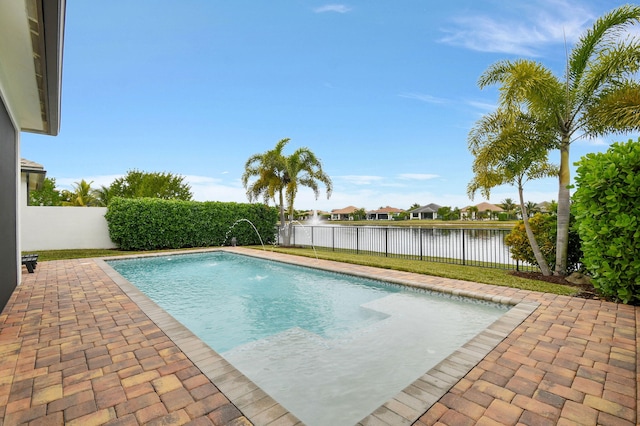 view of swimming pool with pool water feature and a water view