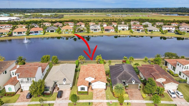 birds eye view of property with a water view