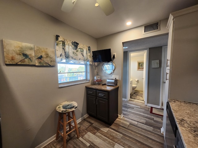 kitchen with ceiling fan and dark hardwood / wood-style floors