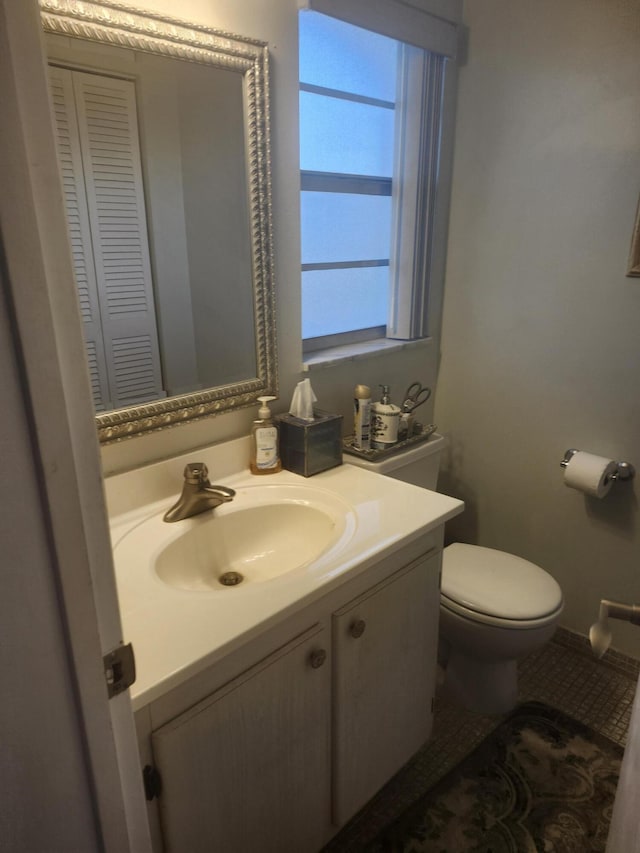 bathroom featuring toilet and vanity