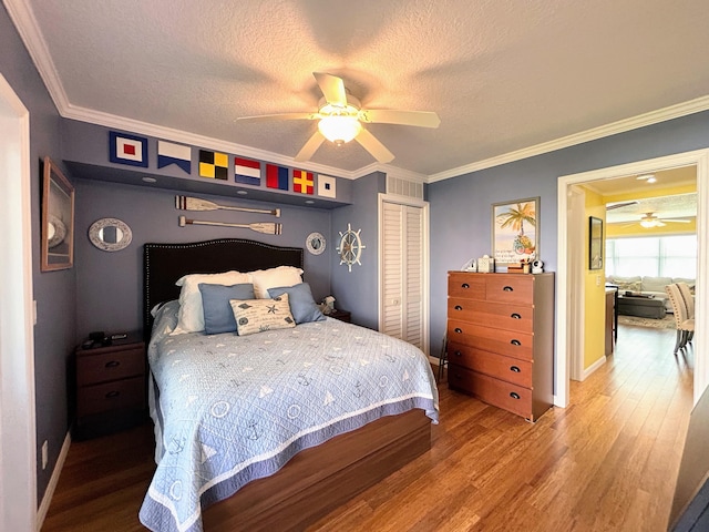 bedroom featuring a textured ceiling, ceiling fan, wood-type flooring, a closet, and crown molding