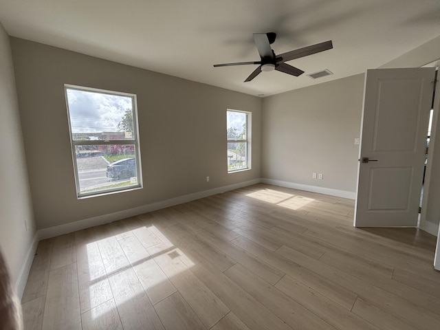 spare room featuring light wood-type flooring and ceiling fan