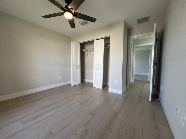 unfurnished bedroom with a closet, ceiling fan, and light hardwood / wood-style flooring