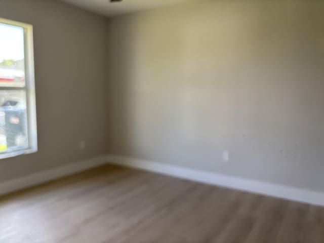 unfurnished room featuring hardwood / wood-style floors