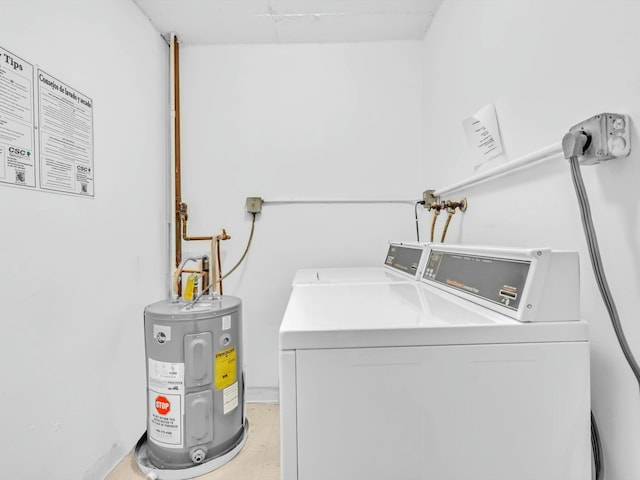 clothes washing area featuring separate washer and dryer and electric water heater