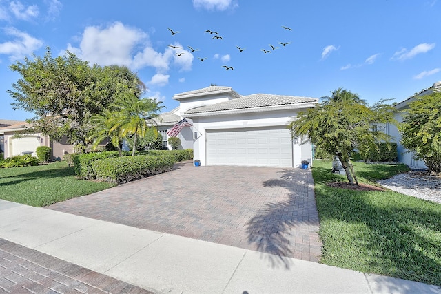 view of front of home with a garage and a front lawn