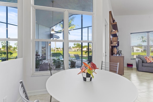 tiled dining space featuring a healthy amount of sunlight