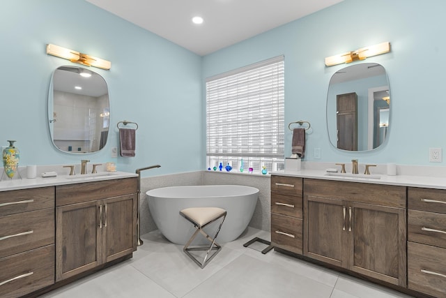 bathroom featuring vanity, tile patterned floors, a bathtub, and tile walls