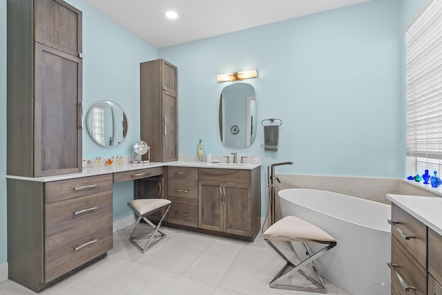 bathroom featuring tile patterned floors, vanity, and a bathtub