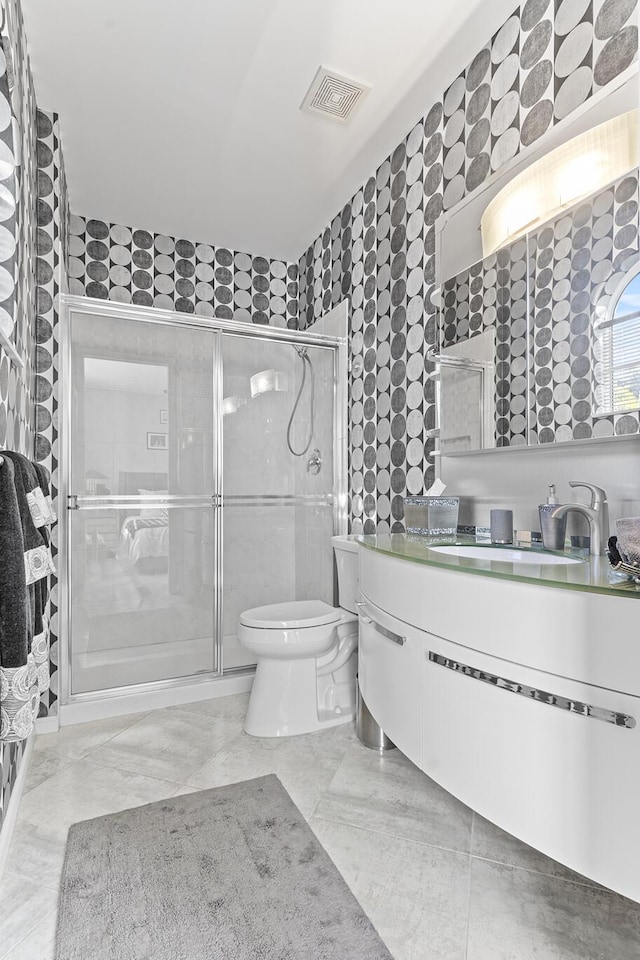 bathroom with vanity, toilet, and an enclosed shower