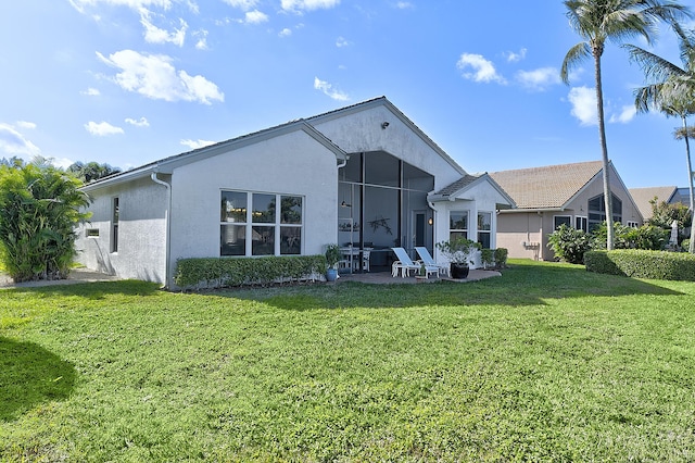 rear view of property with a lawn