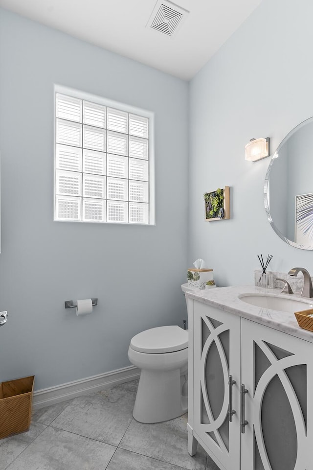 bathroom with tile patterned floors, vanity, and toilet