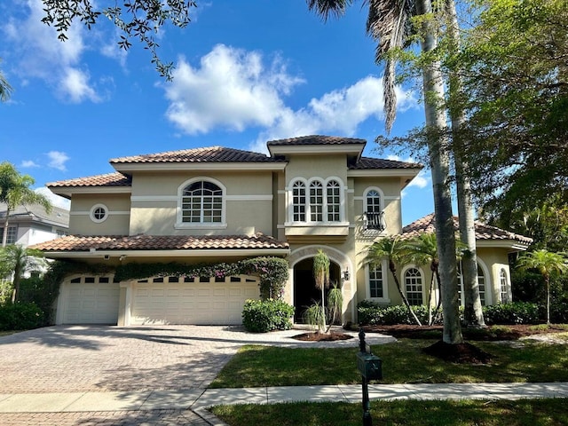 mediterranean / spanish home with a garage