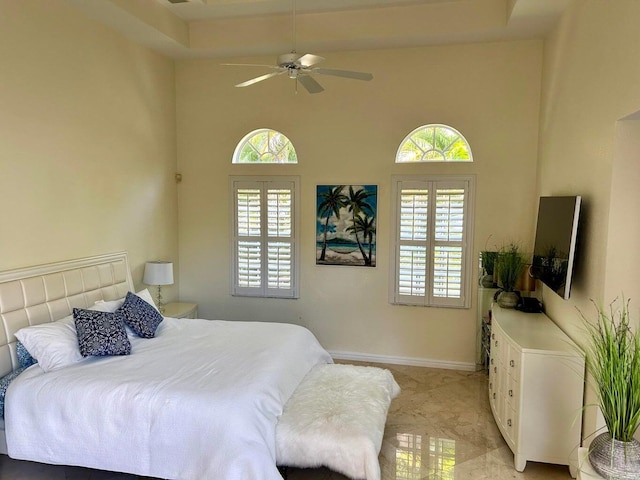 bedroom featuring multiple windows and ceiling fan