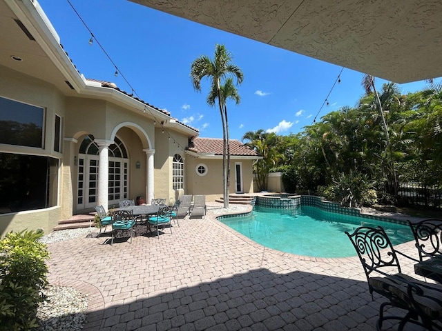 view of pool featuring an in ground hot tub and a patio