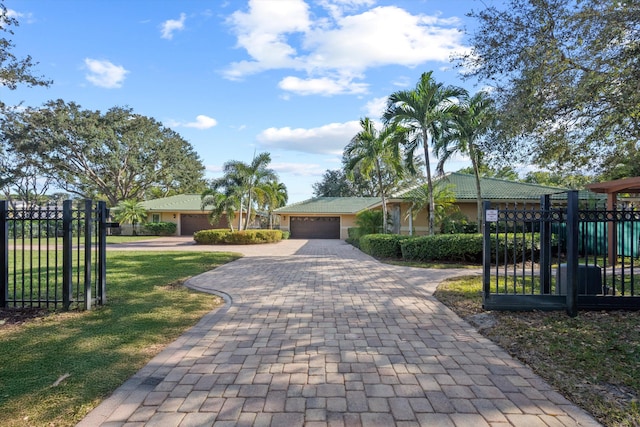 view of front of property featuring a garage and a front yard