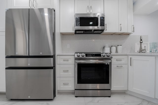 kitchen featuring appliances with stainless steel finishes and white cabinets