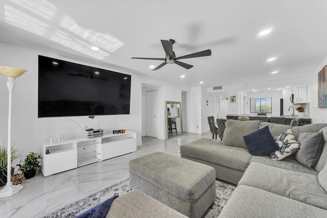 living room featuring sink and ceiling fan