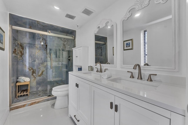 bathroom featuring vanity, toilet, and a shower with shower door