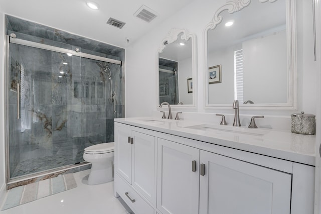 bathroom with vanity, toilet, and an enclosed shower