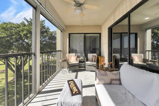 sunroom / solarium featuring ceiling fan