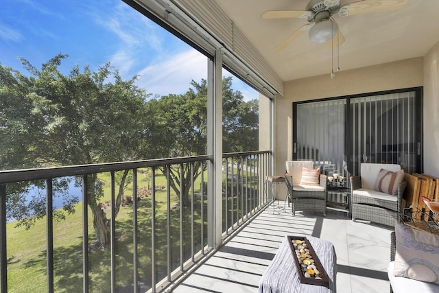 sunroom featuring ceiling fan