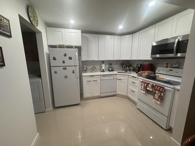 kitchen with washer / clothes dryer, white cabinetry, and white appliances