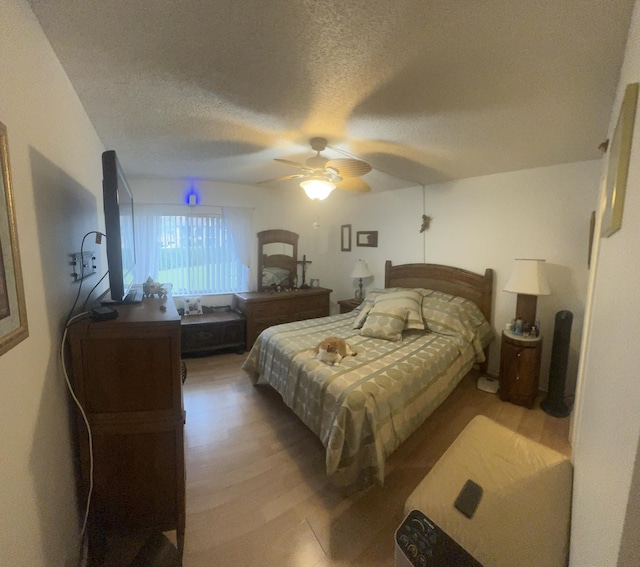 bedroom featuring a textured ceiling, hardwood / wood-style flooring, and ceiling fan