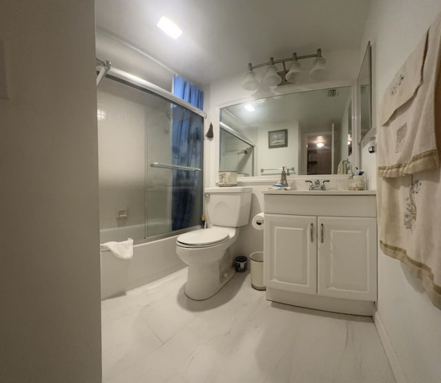 full bathroom featuring combined bath / shower with glass door, vanity, and toilet