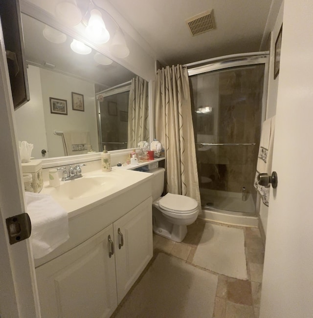 bathroom with vanity, an enclosed shower, and toilet