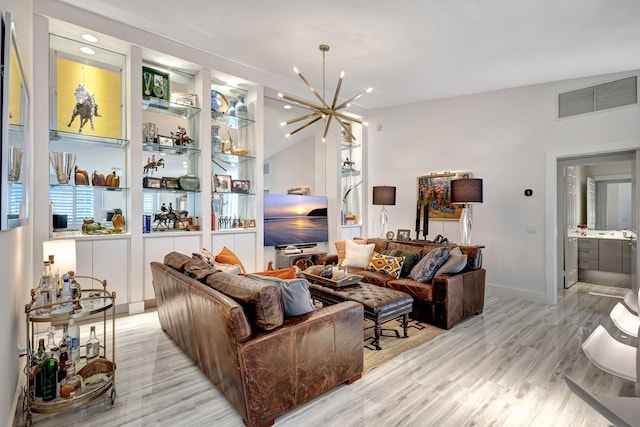 living room featuring a notable chandelier and light hardwood / wood-style floors