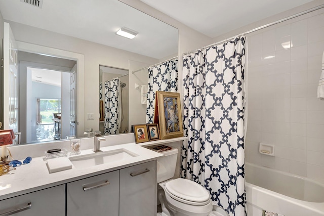 full bathroom with vanity, shower / bath combination with curtain, and toilet