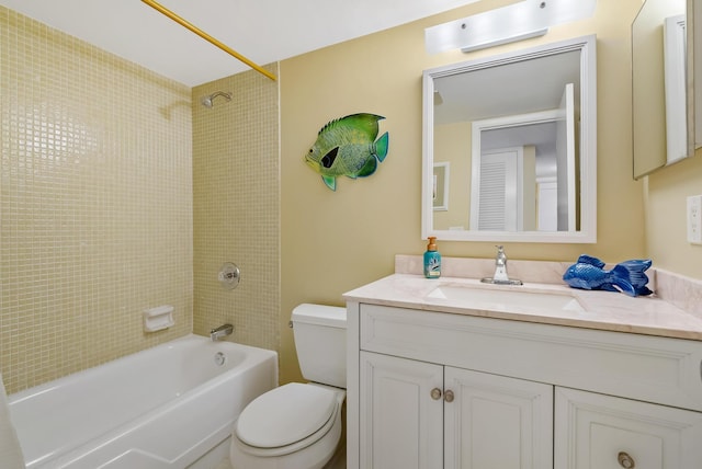 full bathroom featuring toilet, vanity, and tiled shower / bath