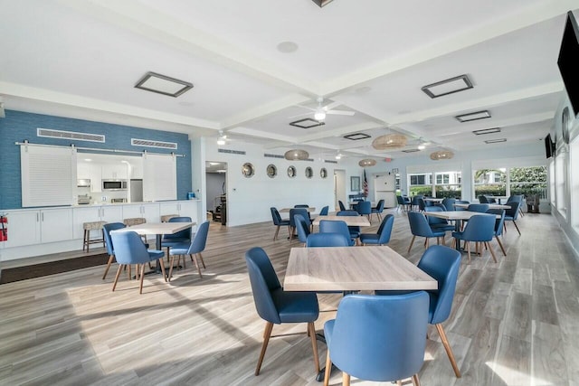 dining room with coffered ceiling, ceiling fan, beam ceiling, and light hardwood / wood-style flooring