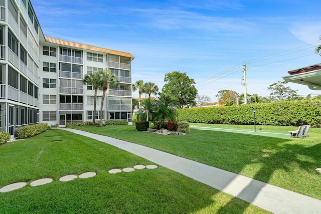 view of property's community with a lawn