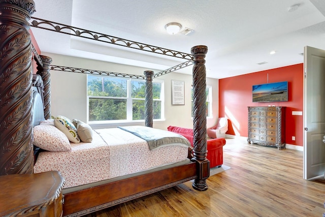 bedroom featuring hardwood / wood-style floors and a textured ceiling