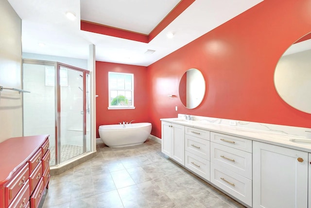 bathroom featuring vanity, independent shower and bath, and a raised ceiling