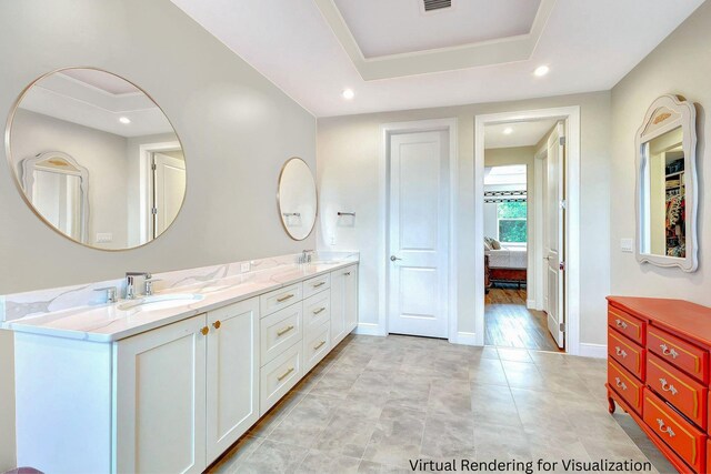 bathroom featuring vanity and a tray ceiling