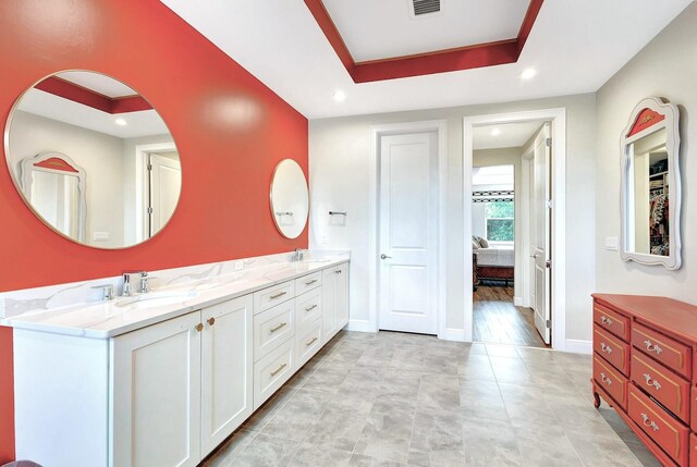 bathroom featuring vanity and a raised ceiling