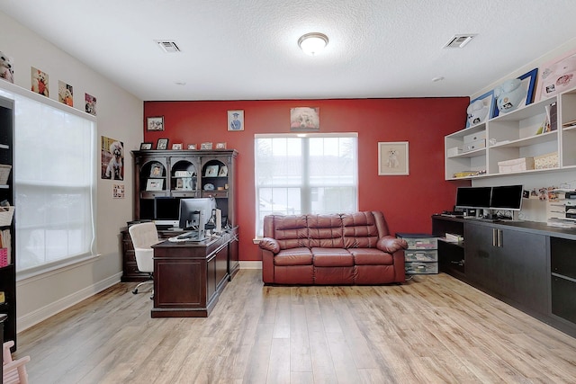 office featuring a textured ceiling and light hardwood / wood-style floors