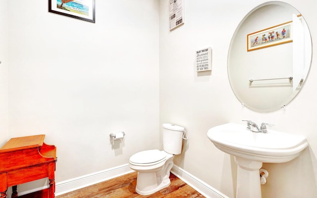 bathroom with wood-type flooring and toilet