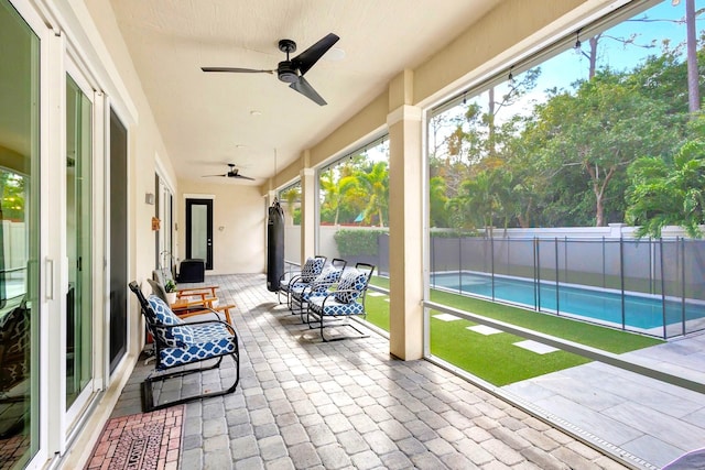 sunroom / solarium with ceiling fan