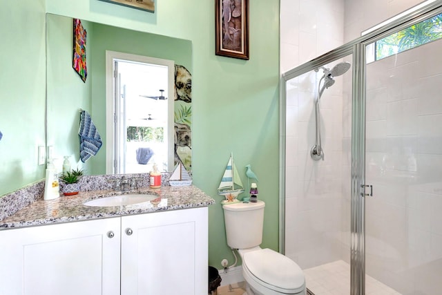 bathroom with toilet, vanity, and walk in shower