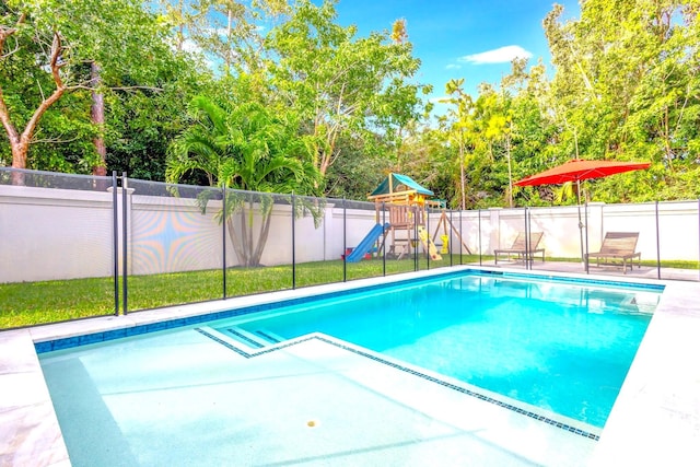 view of swimming pool featuring a playground