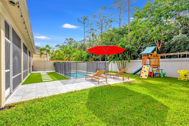 view of yard featuring a playground, a patio, and a fenced in pool