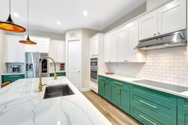 kitchen with pendant lighting, green cabinetry, stainless steel appliances, and white cabinets