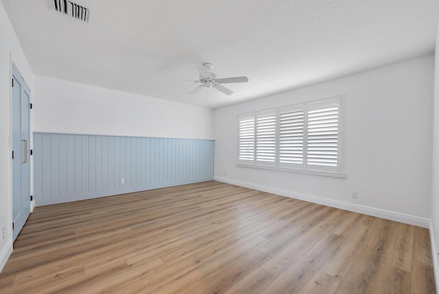 spare room featuring ceiling fan and light wood-type flooring