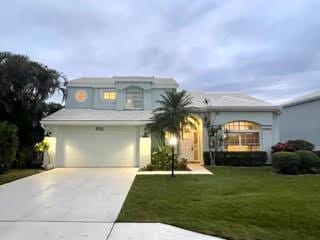 front of property with a garage and a front lawn